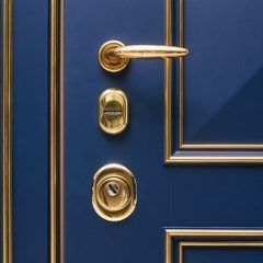 Blue door with gold trim and hardware.
