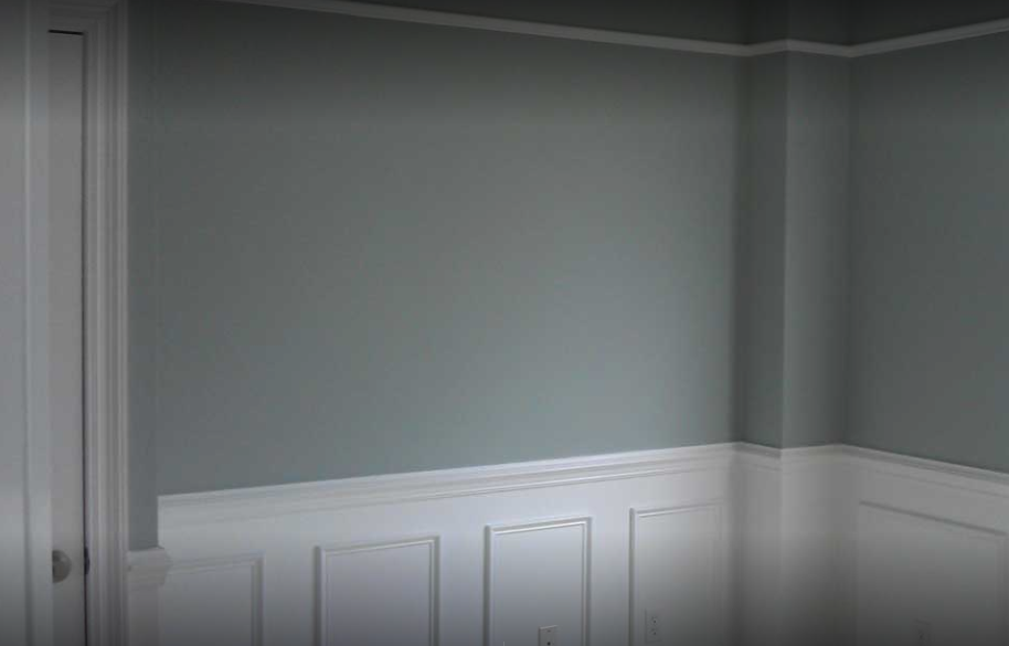 Gray painted walls with white paneling.