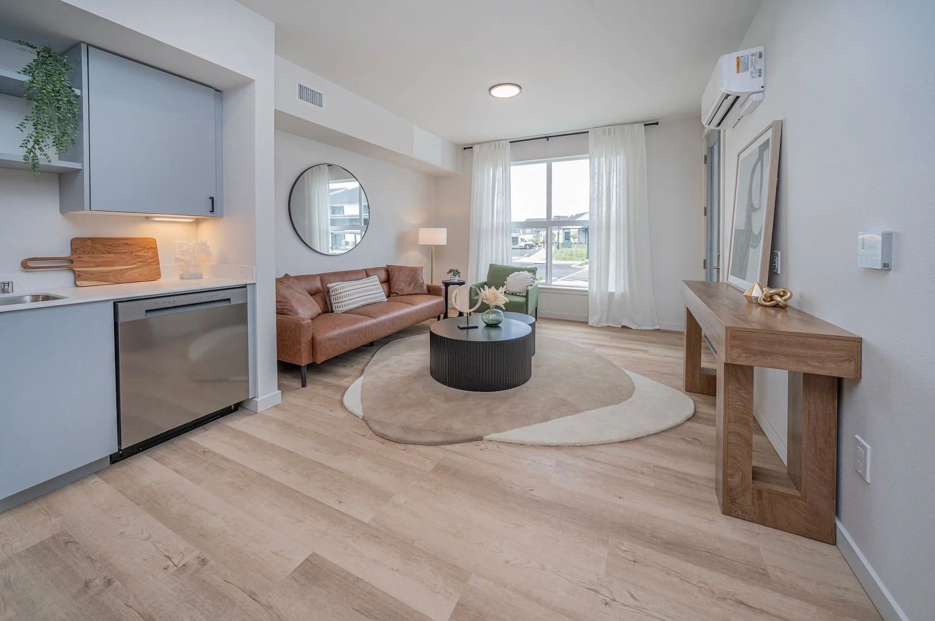 Bright living room in Signal Point Apartments featuring a couch and table, showcasing a welcoming and cozy atmosphere.