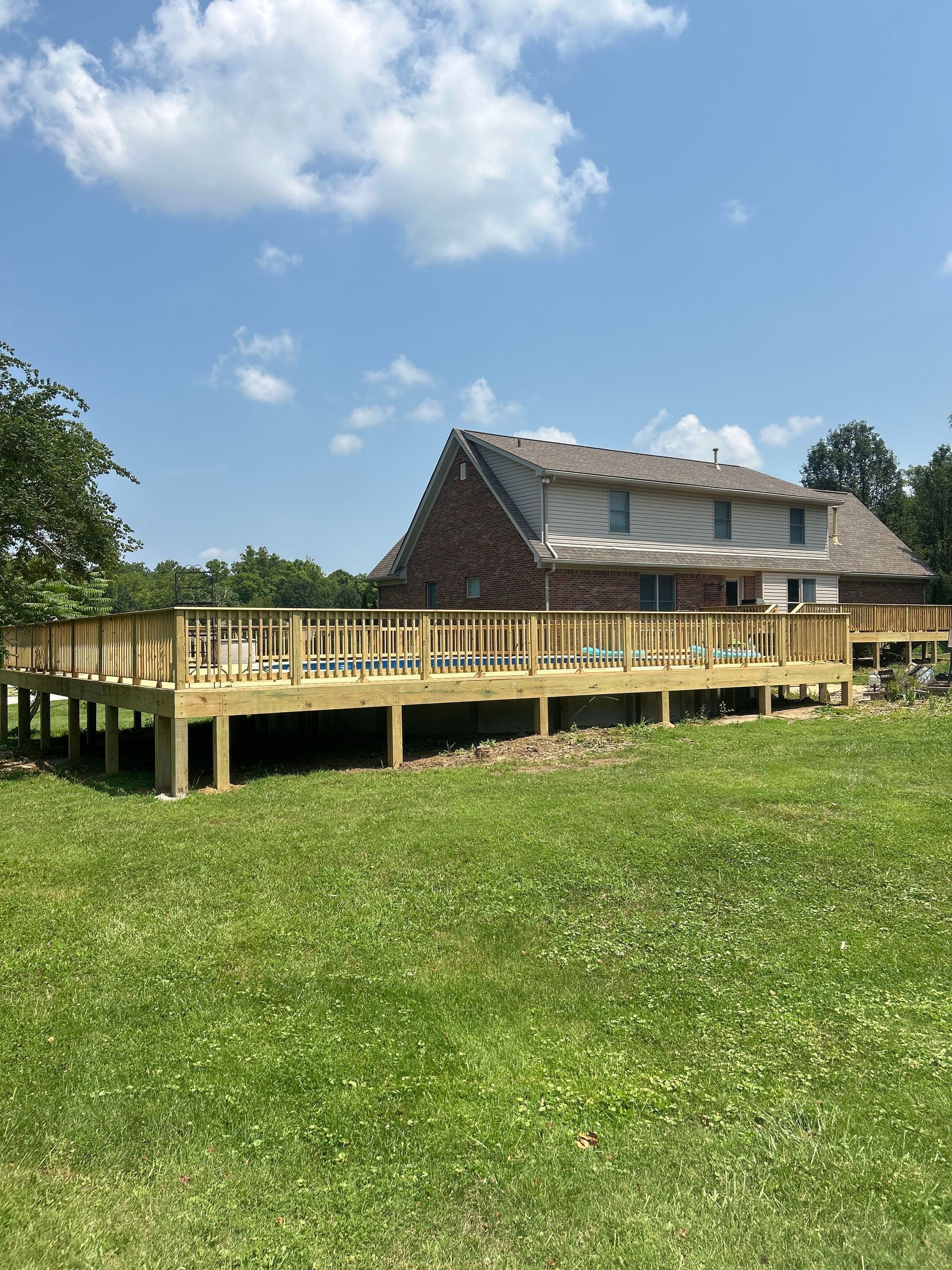 20x20 backyard wood deck installation with custom stair landing