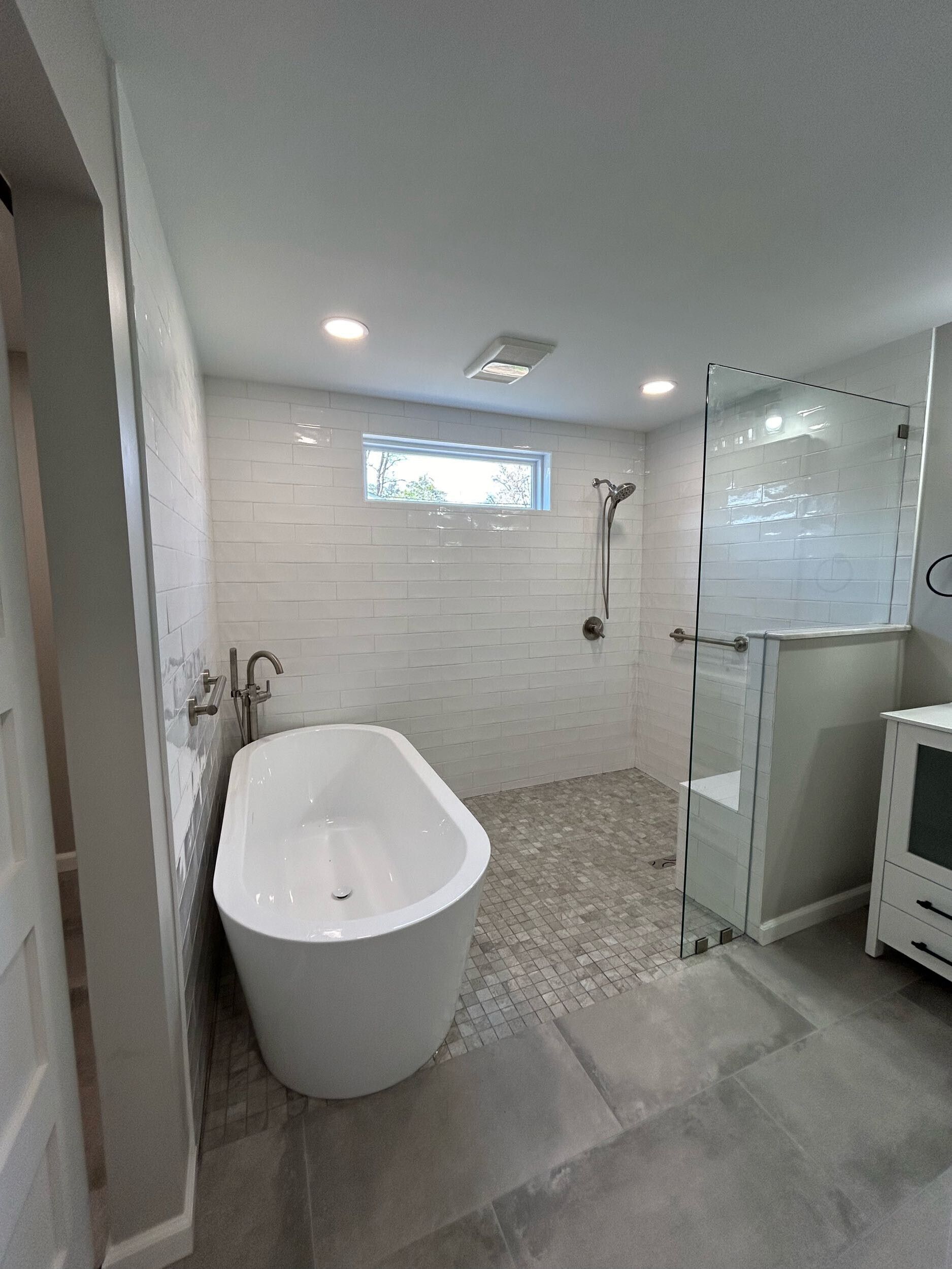 A bathroom with a bathtub and a shower.