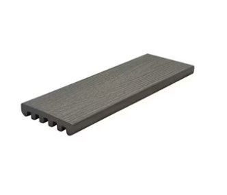 A gray wooden plank is sitting on a white surface.