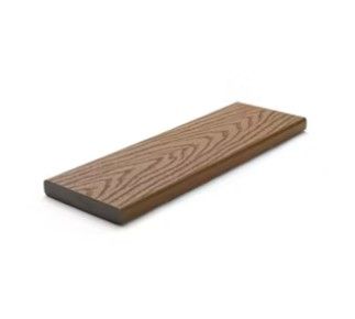 A wooden plank is sitting on a white surface.