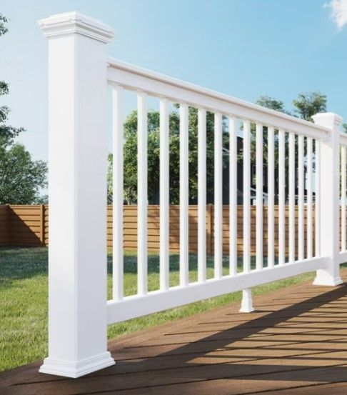 A white fence is sitting on top of a wooden deck.