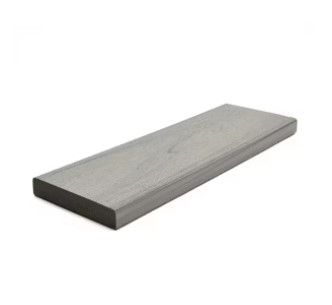 A long piece of wood is sitting on a white surface.
