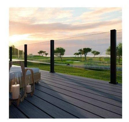 A wooden deck with a glass railing and candles on it.