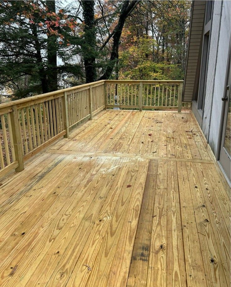 Custom-built Trex composite deck with black aluminum railing in Louisville backyard