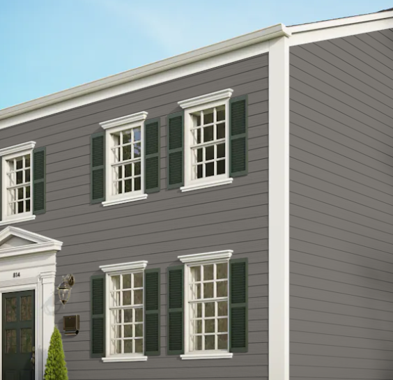 A gray house with white trim and green shutters