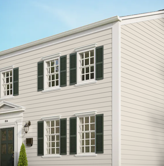 A white house with green shutters on the windows