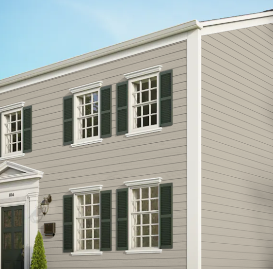 A house with a lot of windows and green shutters