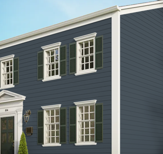 A blue house with white trim and green shutters