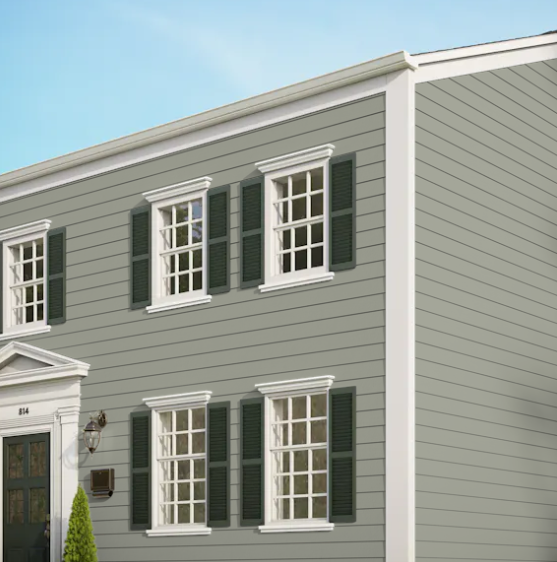 A grey house with white trim and black shutters