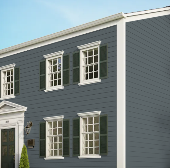 A gray house with white trim and green shutters