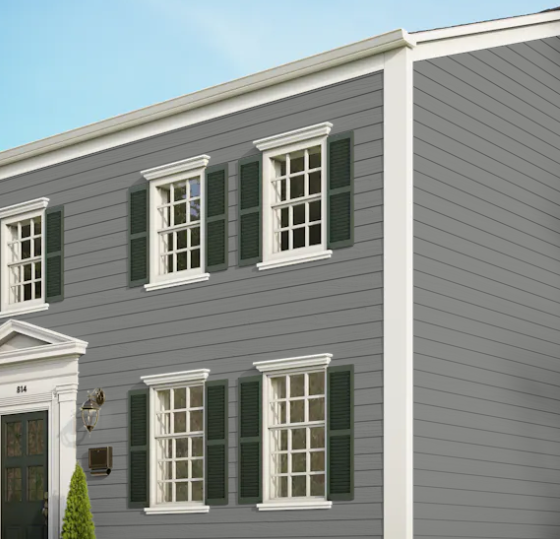 A gray house with white trim and green shutters