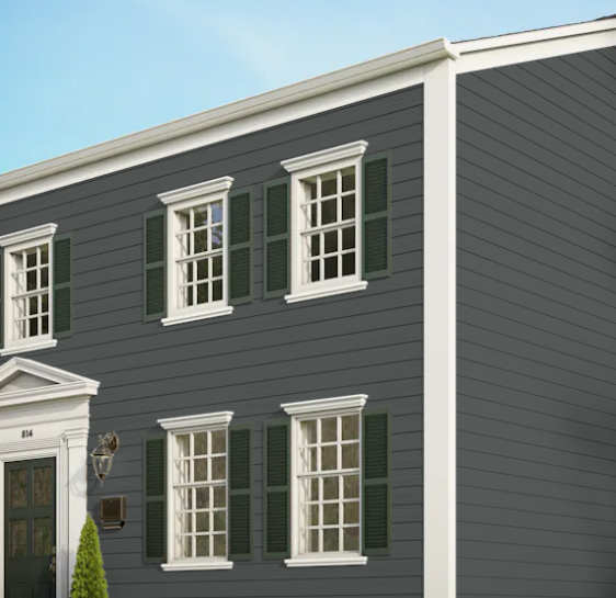 A gray house with white trim and green shutters