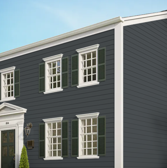 A gray house with white trim and green shutters