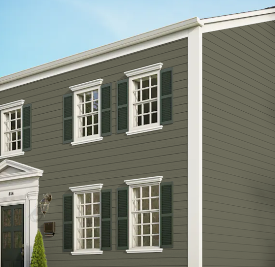 A grey house with white trim and black shutters