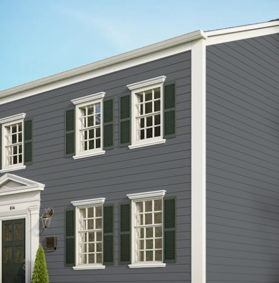 A gray house with white trim and green shutters