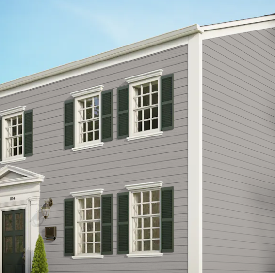 A gray house with white trim and green shutters