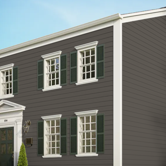 A gray house with white trim and green shutters