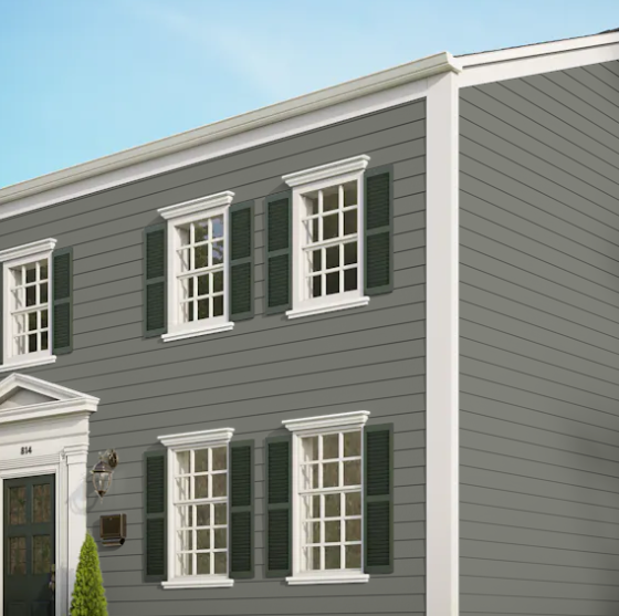 A gray house with white trim and green shutters