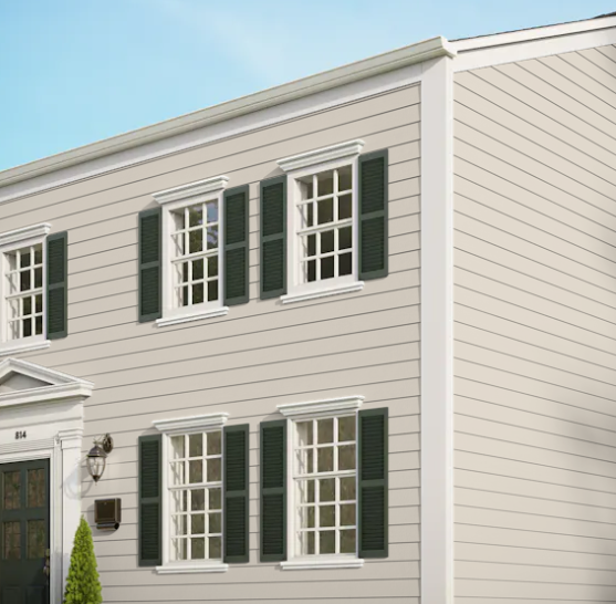 A white house with green shutters on the windows