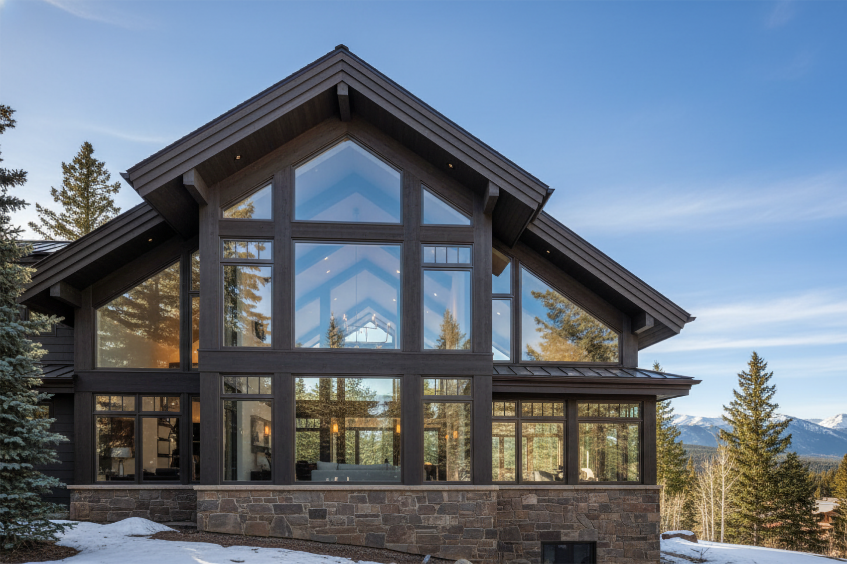 Contemporary Colorado mountain home with expansive custom window wall showcasing Rocky Mountain view
