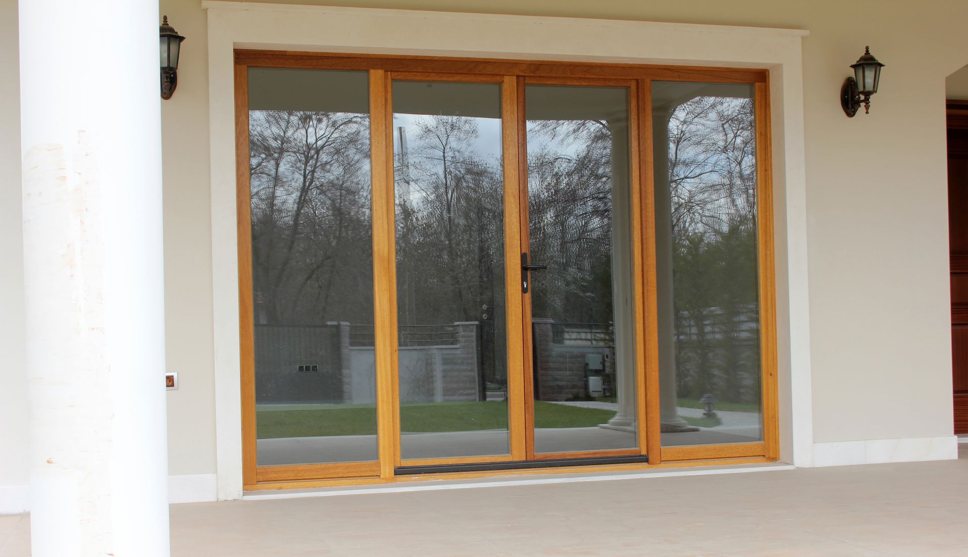 Wood-framed sliding glass patio door in winter