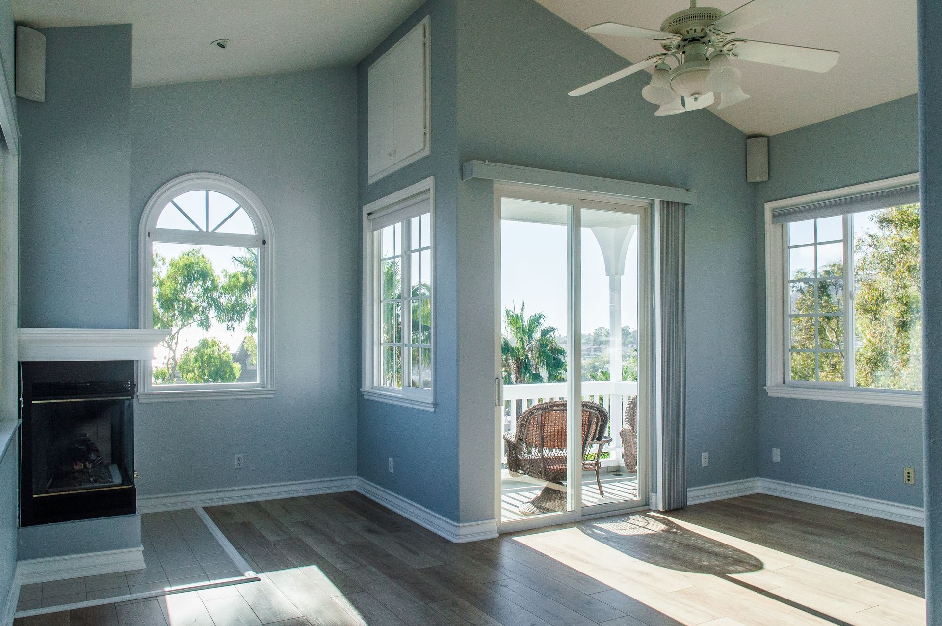 Bright Colorado living room with large sliding patio doors leading to outdoor balcony, showing natural light and modern energy-efficient design