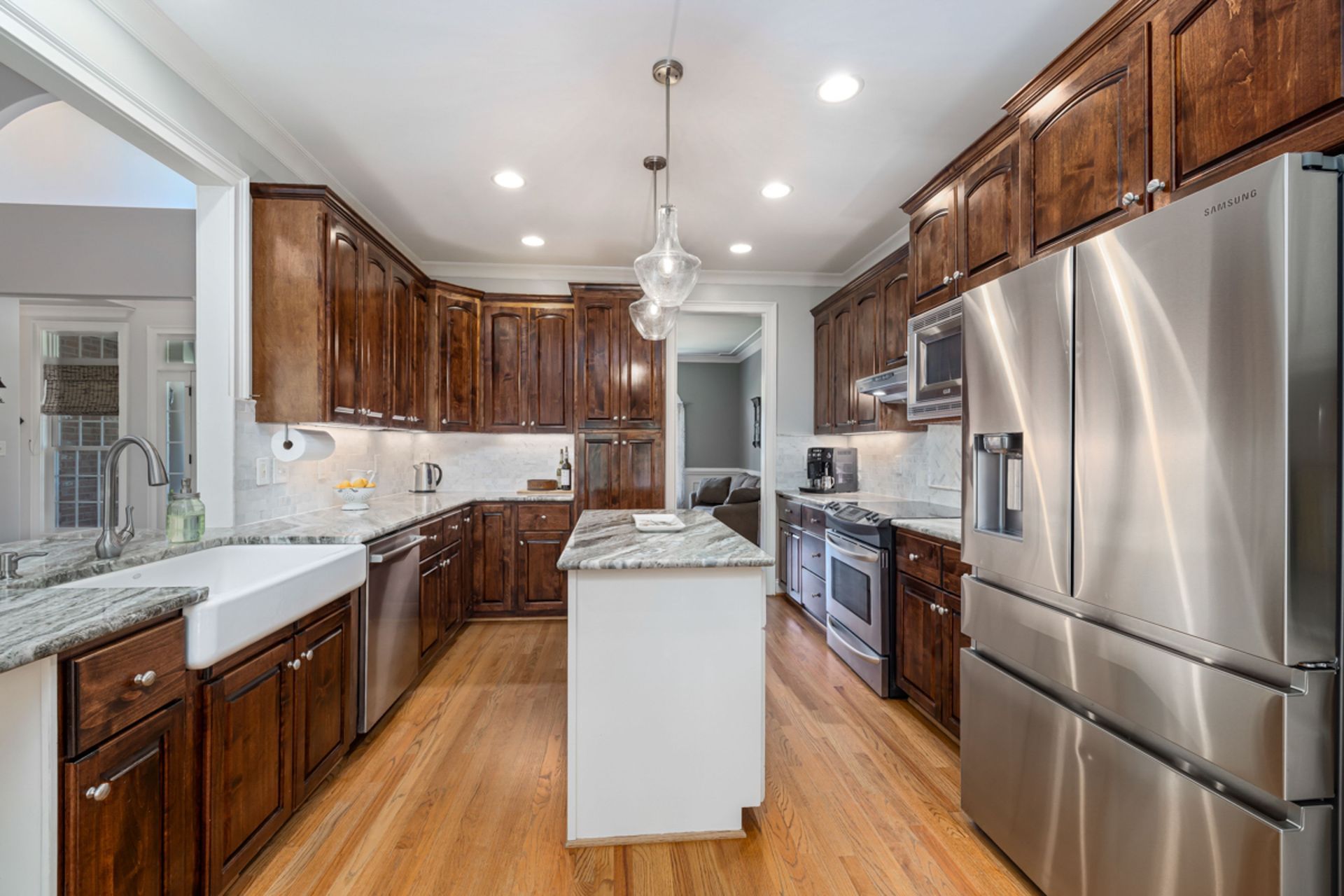Modern kitchen with stainless steel appliances, wood cabinets, and a central island