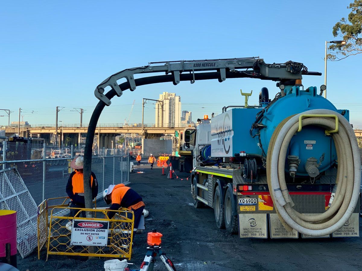 a vacuum truck is being used to clean a construction site .