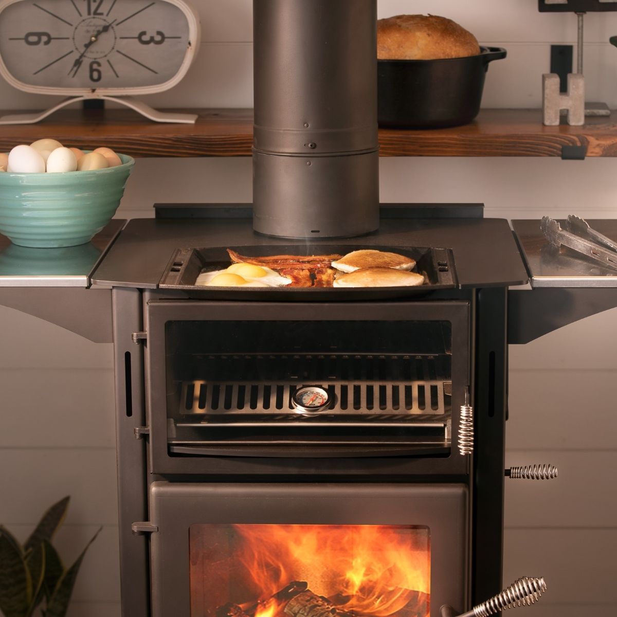 A wood stove with a tray of food on top of it