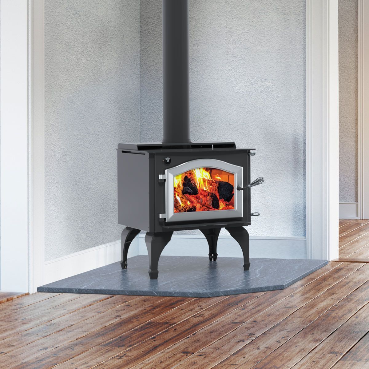 A wood stove is sitting on a wooden floor in a room.