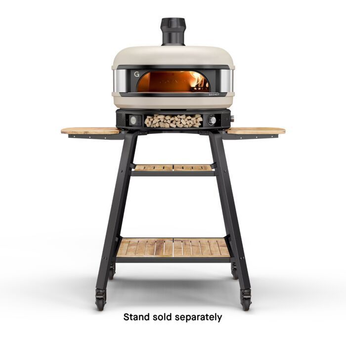 A pizza oven on a stand with the words stand sold separately on the bottom