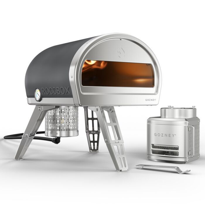 A pizza oven is sitting on a white surface.