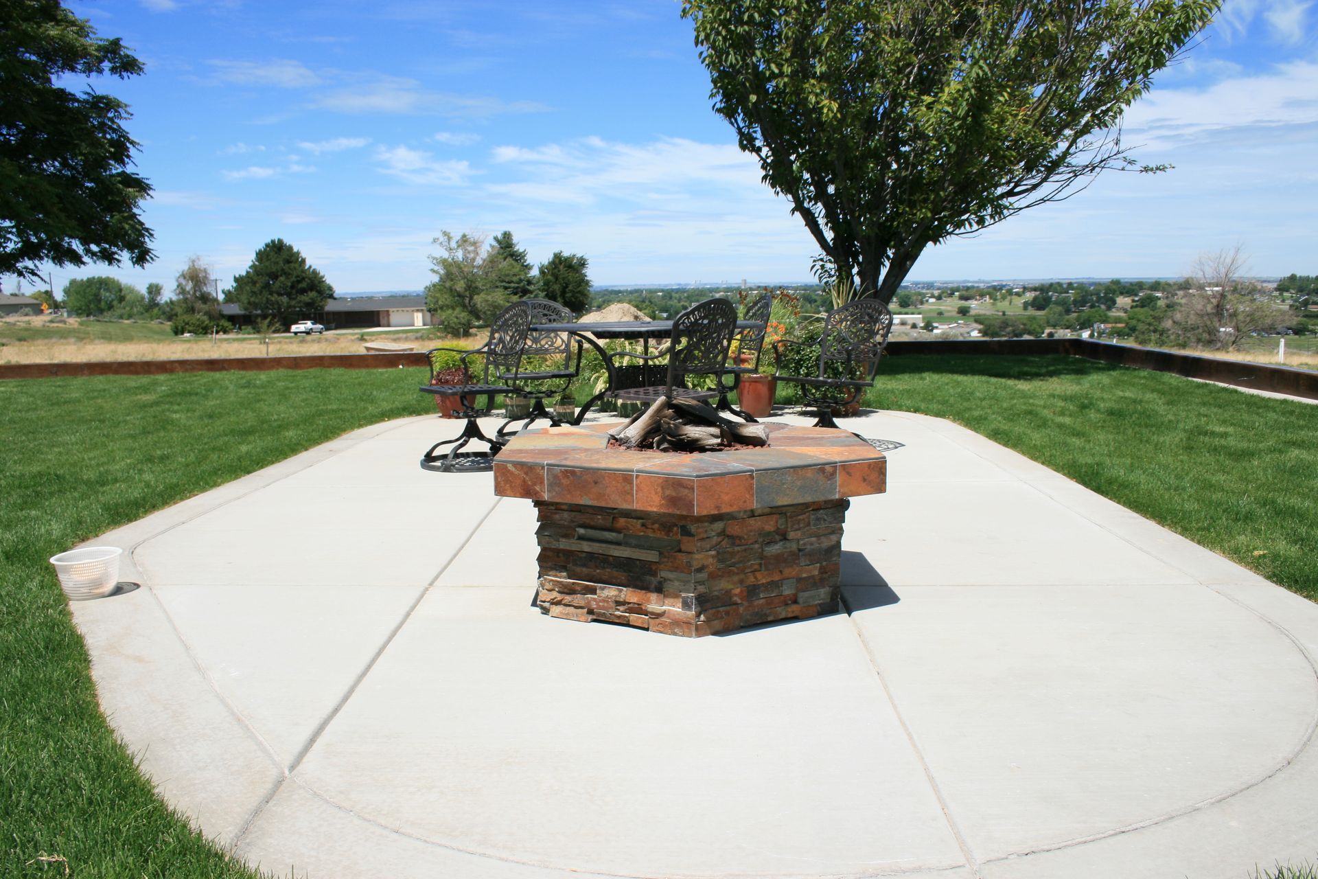 A fire pit with a table and chairs around it