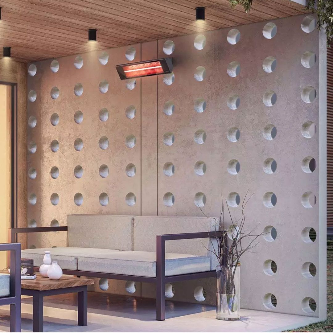 A living room with a couch and a table in front of a wall with holes in it