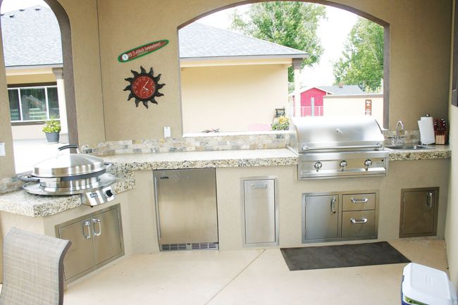 A kitchen with a grill and a clock on the wall