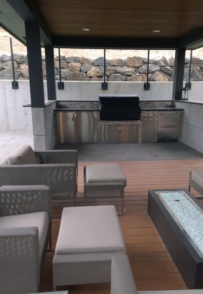 A patio area with a fire pit and a grill