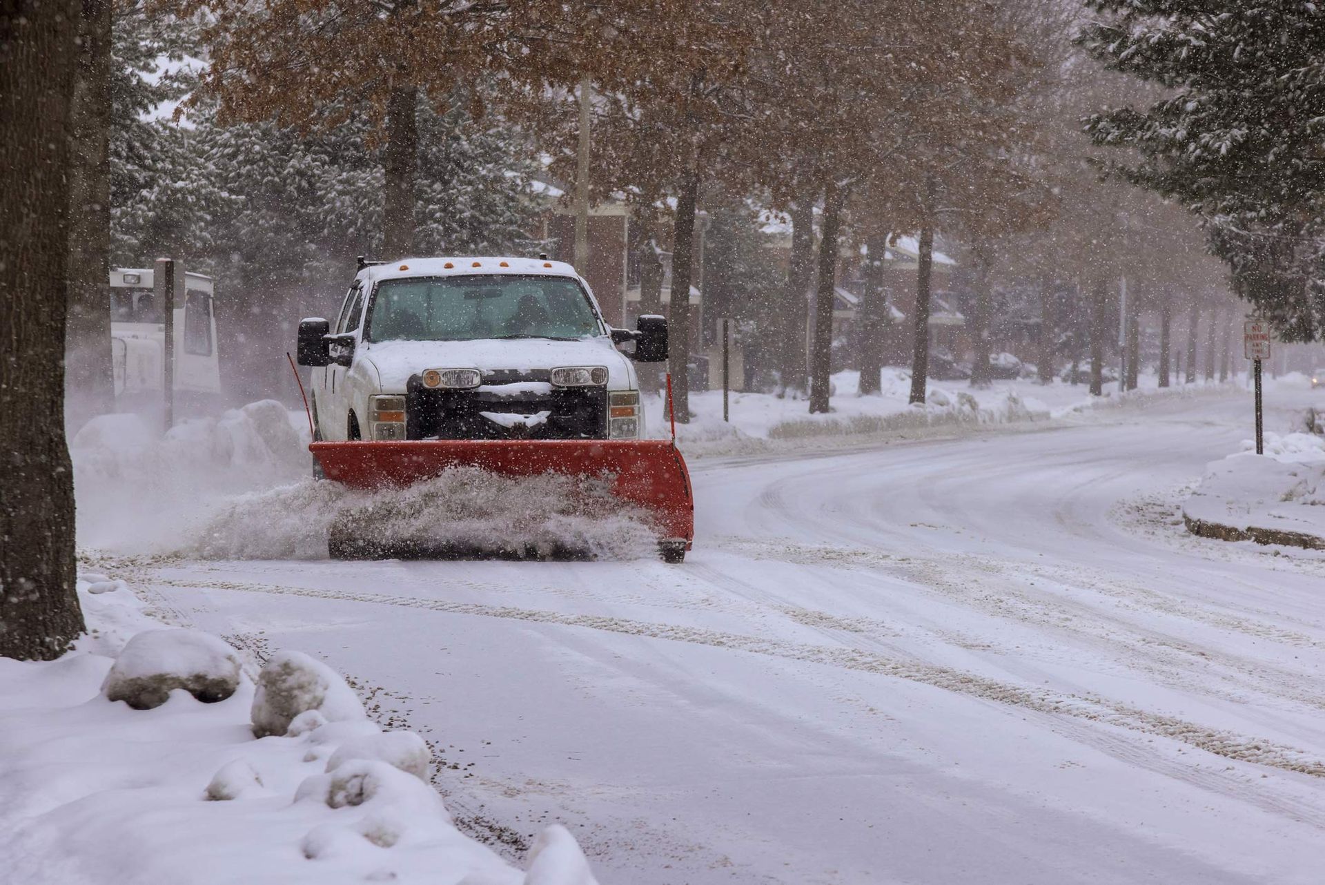 Commercial snow removal services in action as winter truck clears snow from streets. Commercial snow removal services in action as winter truck clears snow from streets.