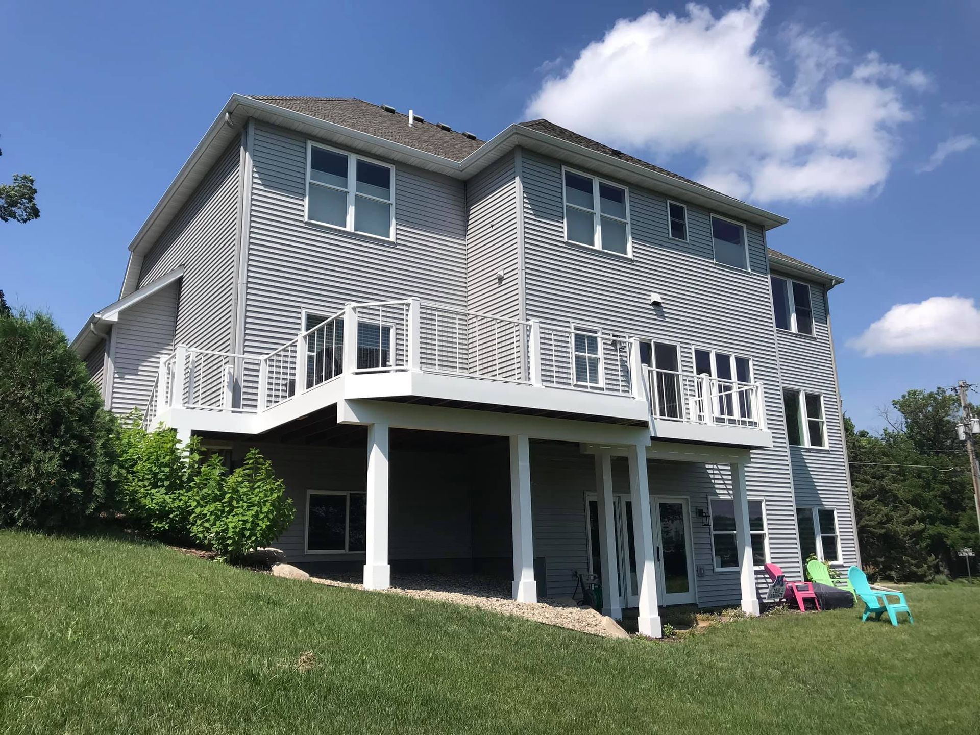 A house with a large deck and stairs leading up to it