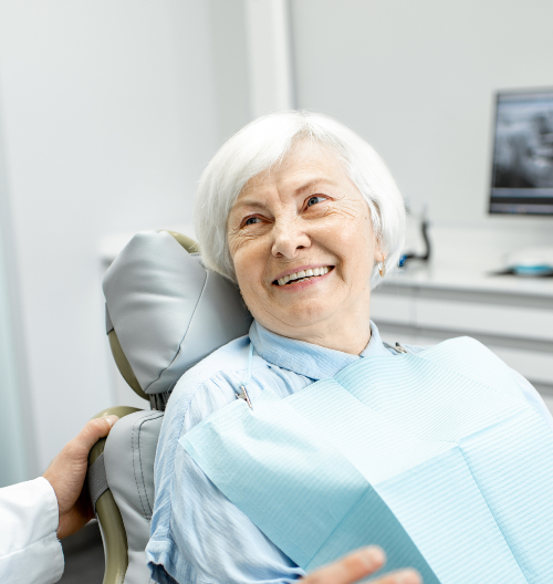 old woman smiling at dentist | Get smile in a day makeovers in Lynnwood WA 98036 | Dental Implants