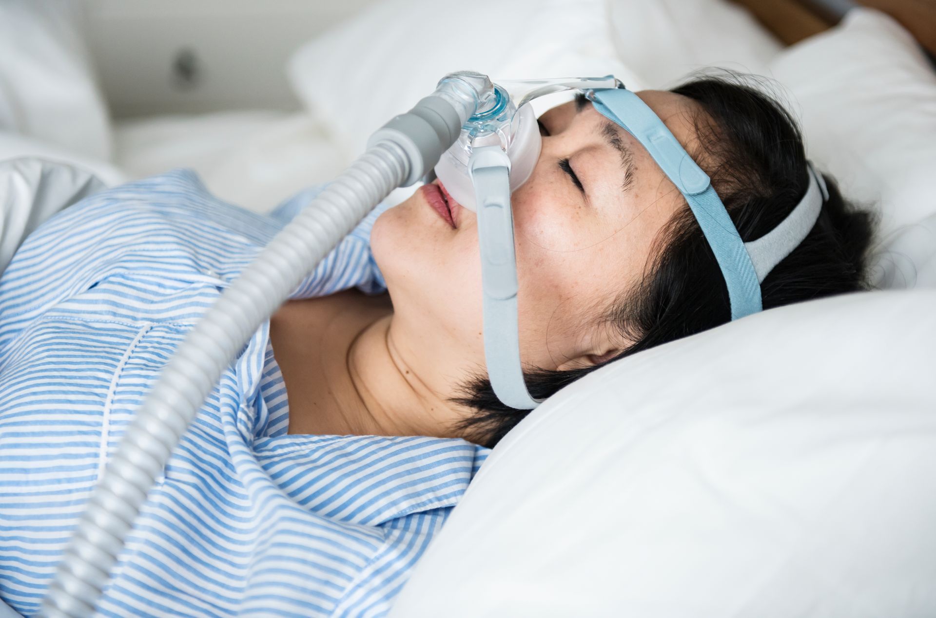 woman with sleep apnea mask on | Dentist near Lynnwood WA