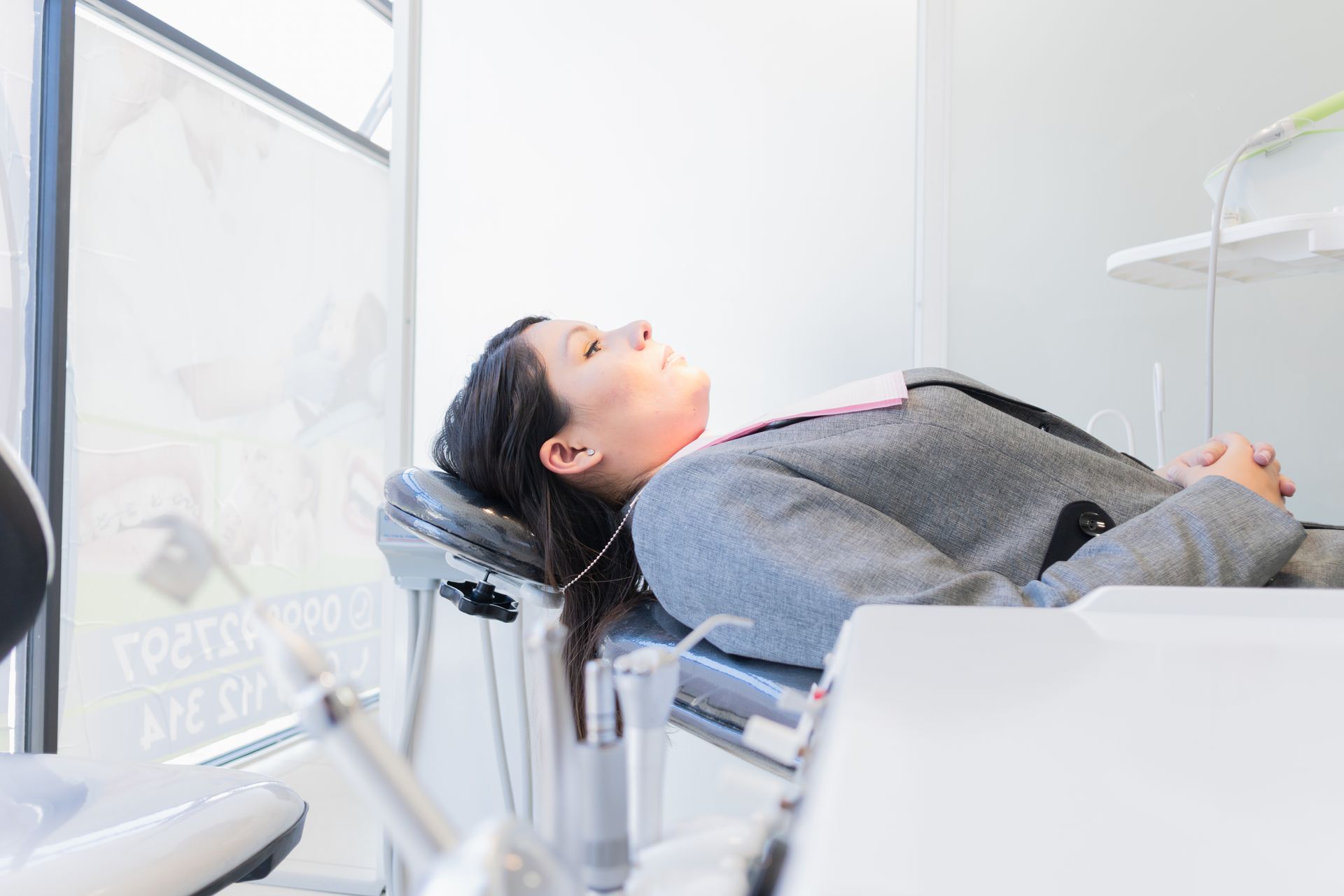 woman laying down getting sedation for her smile makeover in Lynnwood WA