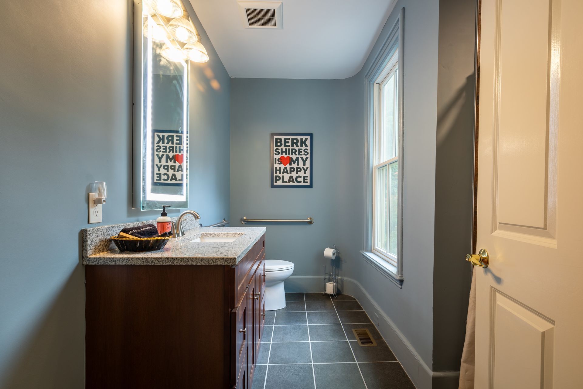 A bathroom with a sign on the wall that says leak in my place