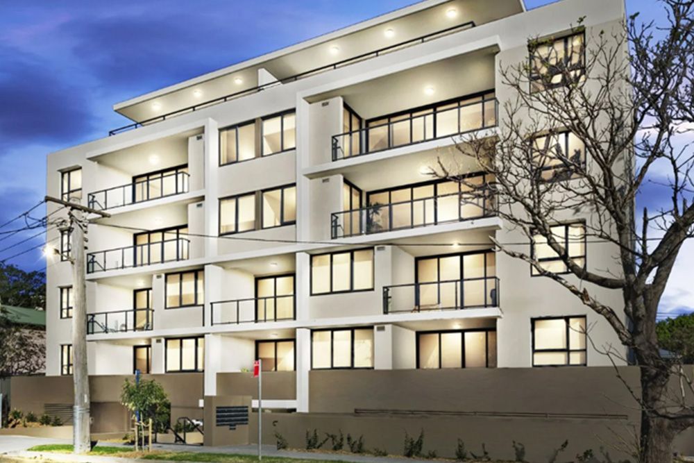 A large apartment building with a lot of windows and balconies.