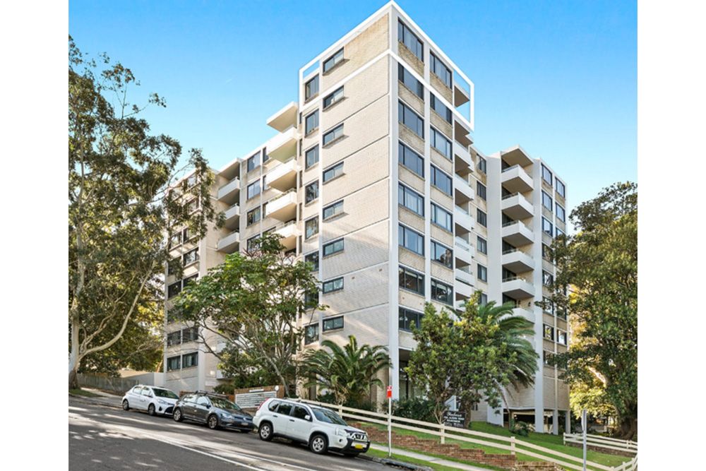 A large white building with cars