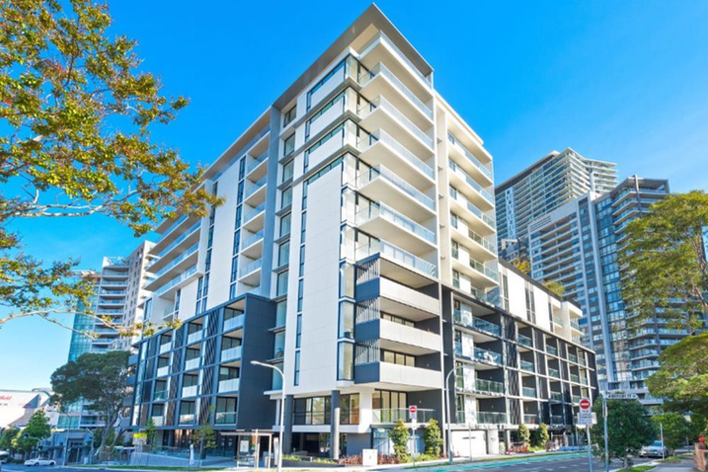 A large apartment building with a lot of windows and balconies