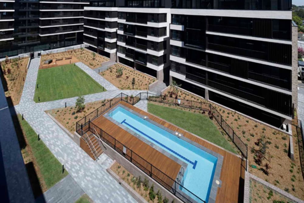 A large building with a swimming pool in the middle of it