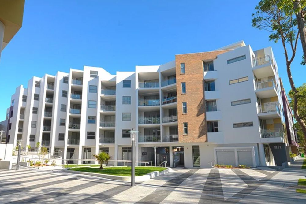 A large apartment building with a lot of windows and balconies
